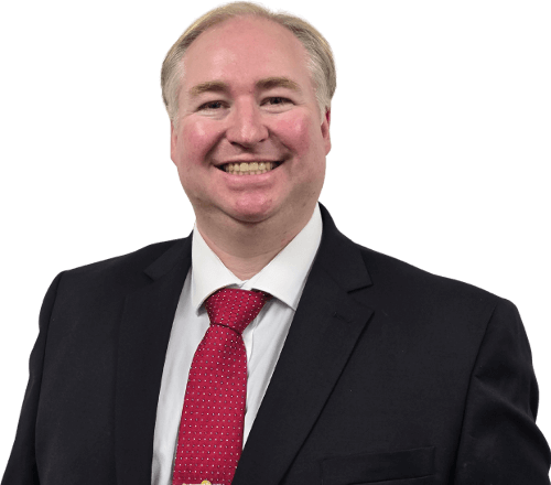 William Wentowski smiling and wearing a black suit with red spotted tie